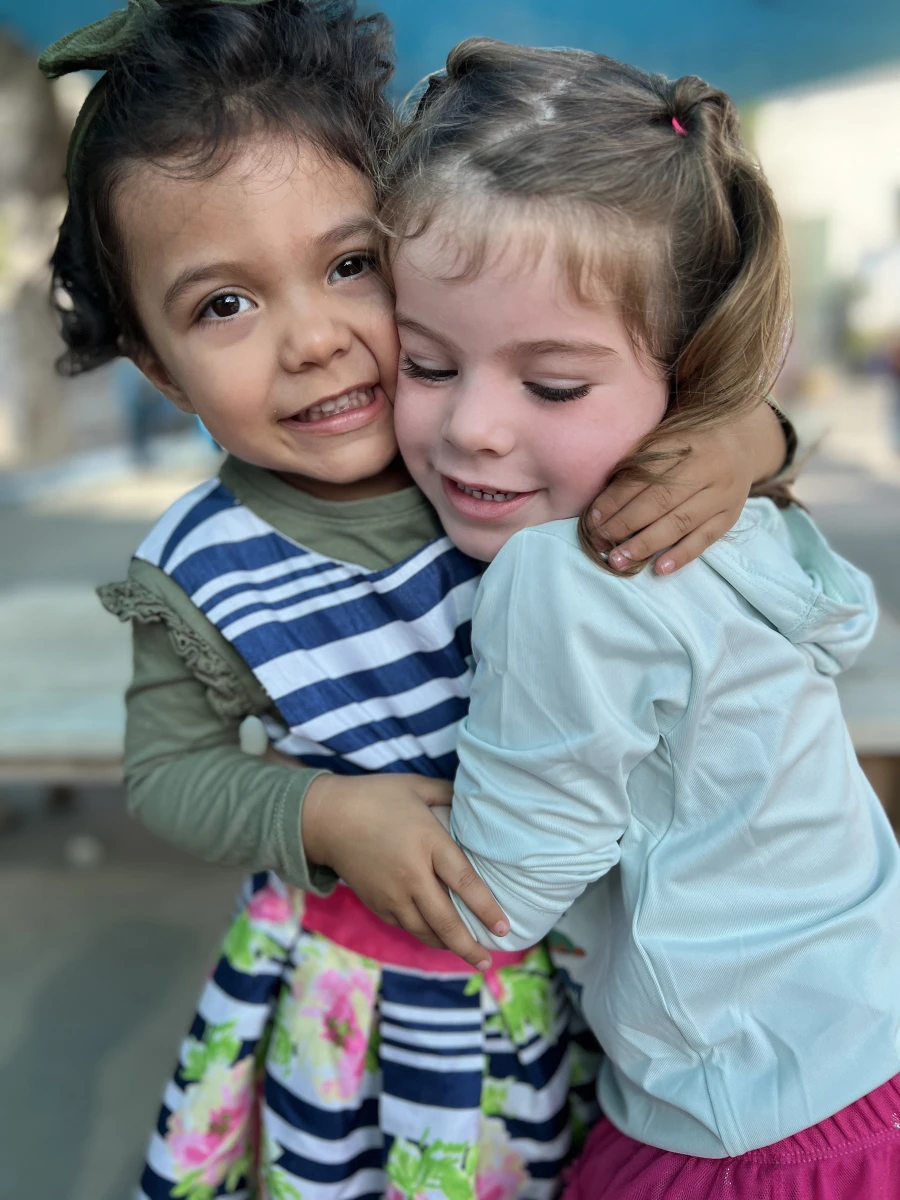 Two children sharing a warm and heartfelt embrace.